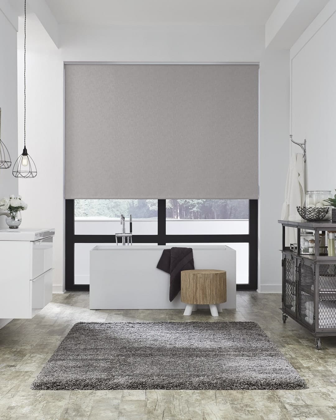 Modern bathroom with a Lutron roller shade and Palladiom keypad, designed interior