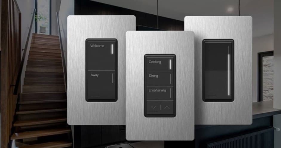Three brushed-metal Lutron keypads with Welcome, Away, and scene buttons by a staircase